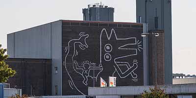 De muurschildering van Keith Haring, gezien vanaf de Willem de Zwijgerlaan